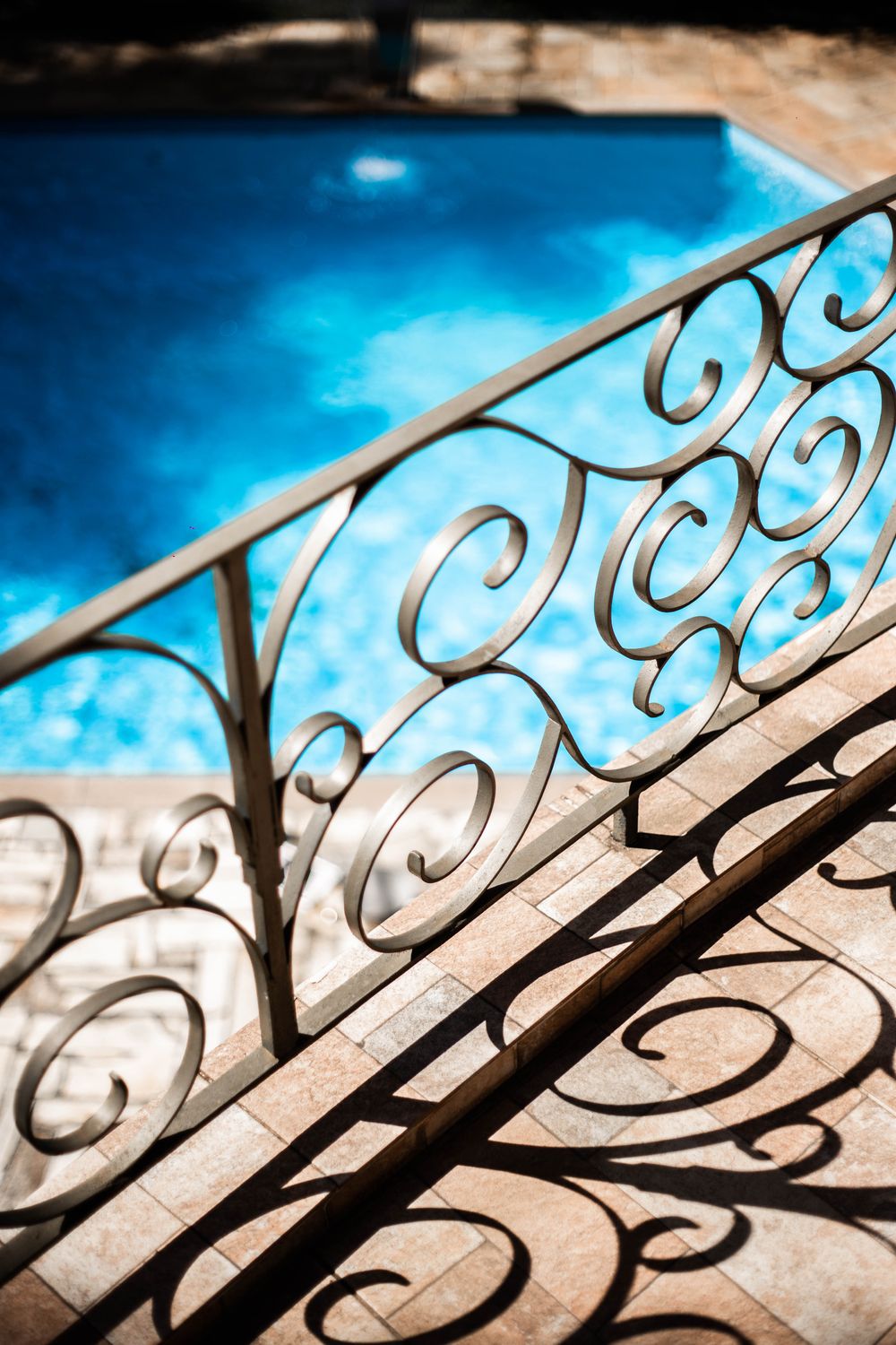 Ornate cream steel railing bordering a garden lawn